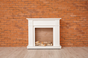 Modern fireplace near wall in room