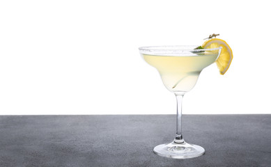 Glass of fresh martini on table against white background