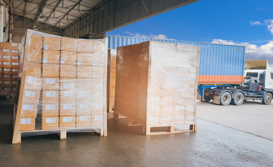 Cargo freight, Shipment, Delivery service. Logistics and transportation. Warehouse docks. Stacked package boxes on pallet waiting to load into cargo container truck.