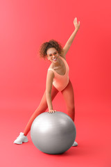 Young woman doing aerobics on color background