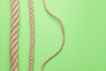 Long ropes on color background