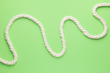 Long rope on color background