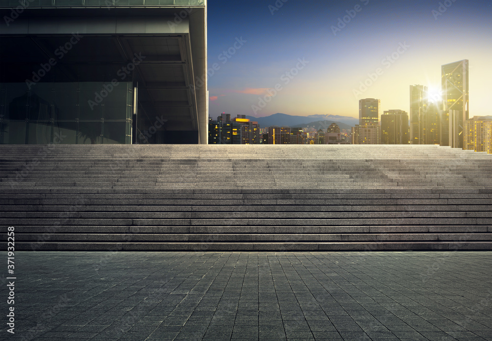 Wall mural empty brick floor and city skyline during sunrise