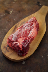 Raw entrecote steak on cutting board