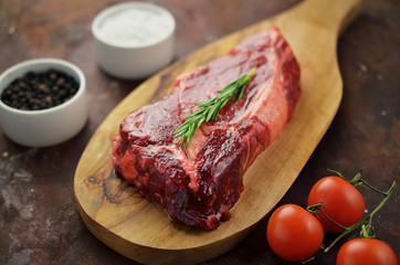 Raw entrecote steak on cutting board