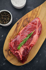 Raw entrecote steak on cutting board