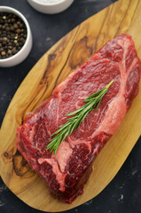 Raw entrecote steak on cutting board