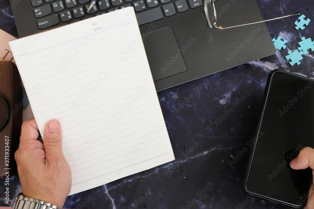Poster notebook and smartphone on wood table and space for text