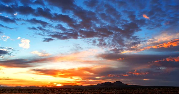 The rising sun paints the sky red in this dramatic time lapse of the desert dawn