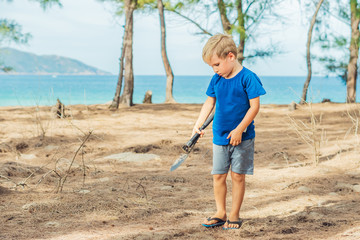 Camping people outdoor lifestyle tourists, summer forest near lazur sea. Blond boy play study...