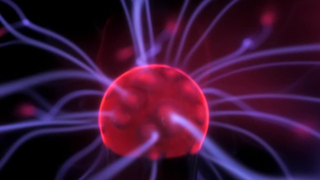 Close up shot of a red ball in the middle of a plasma globe. Blue currents are seen moving fast.