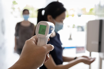 Check body temperature screening using thermometer,prevent people with fever,Coronavirus,cleaning...