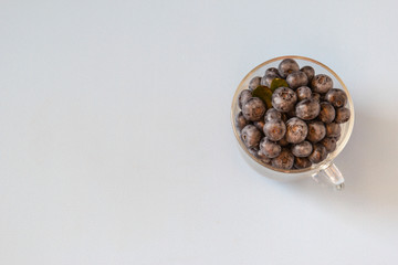 Fresh blueberries in transparent bowl. Fresh blueberries on blue table. Concept for healthy eating and nutrition. Top view. Copy space.