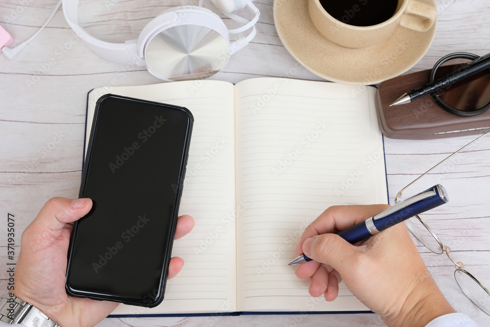 Poster businessman using a smartphone and working on the table