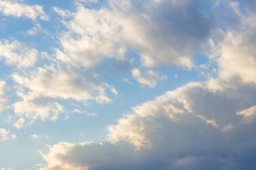 cloudy sky in yellow light. natural background at sunrise. inspiring scene