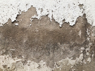 Walls and backgrounds Old cement walls with black stains on the surface caused by moisture. Peeling wall surface with cracks and scratches, old rough gray cement wall surface for the background.