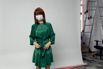 Woman in fashion dress posing in medical mask virus covid-19