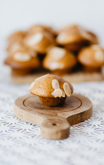 Fototapeta na wymiar selective focus homemade muffin on wooden tray with white table and white background