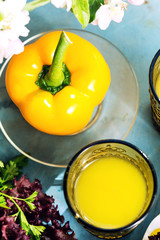 Fresh yellow bell pepper on plate and orange juice