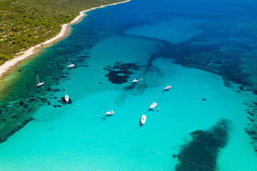 Amazing Adriatic sea in Croatia. Aerial view of azure turquoise lagoon on Sakarun beach on Dugi Otok island, yachts anchored blue sea, tourist paradise.