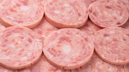 Boiled sausage isolated on white background. Slices.
