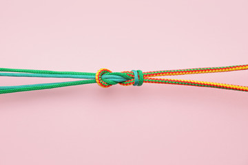 Ropes with knot on color background