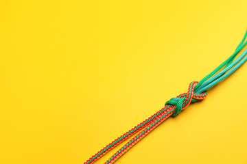Ropes with knot on color background