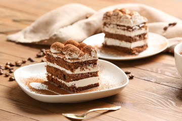 Plate with tasty tiramisu on table