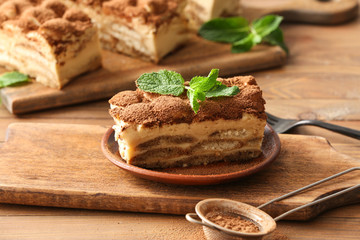 Tasty tiramisu on wooden background
