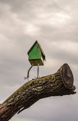 Fairy-tale character -  hut on chicken legs, against the background of  gloomy sky