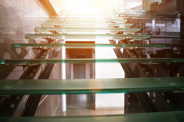 Glass modern staircase in a new building, sunset, background, architectural