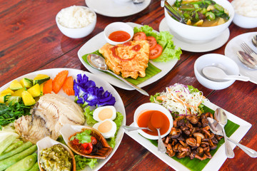 thai food top view , asian food served on wooden table setting with plate menu in thailand /