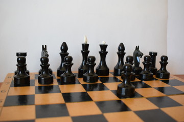 Сhess pieces on a chessboard. First move in chess
