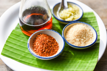 seasoning food with chili powder , sugar , fish sauce and vinegar