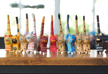 Colorful wooden cats on wooden table