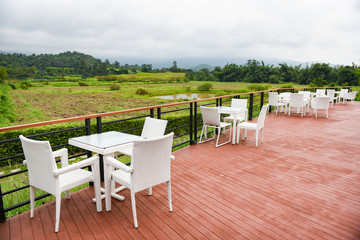 Table and chairs outdoor restaurant - Set of white dining table on terrace and view nature and mountains countryside