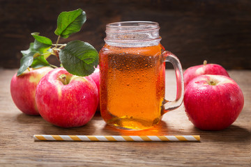 glass jar of apple juice with fresh fruits