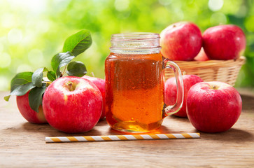 glass jar of apple juice with fresh fruits