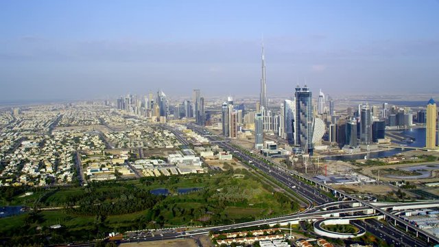 Flying through a panoramic view of the city over the Safa Park and moving in close towards the iconic Burj Khalifa, 6-axis stabilized gimbal, Shotover F1, 8K, parallax.
