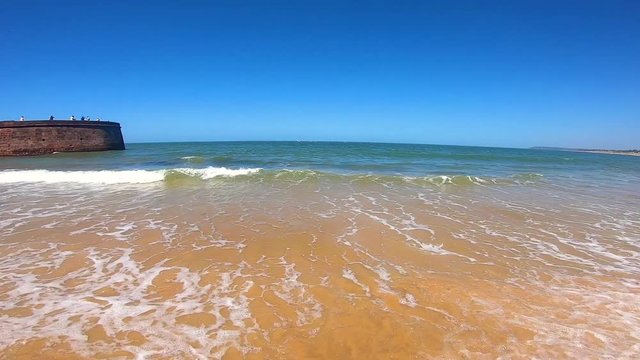 Calm waves breaking on Sinquerim Beach in Goa, India