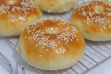 In selective focus a homemade bread in a silver cup on a food grating background 