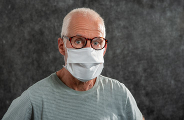 Portrait of an senior man in a medical mask. Concept of the danger of coronavirus