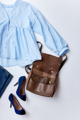 feminine summer fashion composition with blouse, jeans sunglasses,shoes and bag. Flat lay, top view minimalist clothes collage
