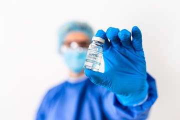 Female doctor holding COVID-19 vaccine. Healthcare And Medical concept.Vaccine vial dose flu shot...
