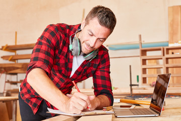 Handwerker mit Checkliste und Laptop