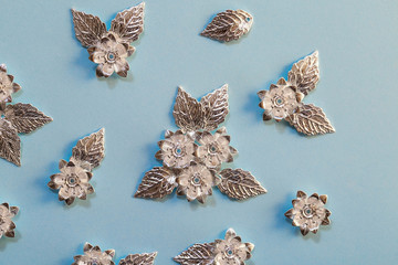 Silver details for creating jewelry, beading, and clothing design. Metal flowers and leaves close up