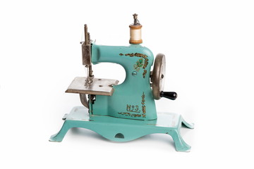 Old blue sewing machine on white background