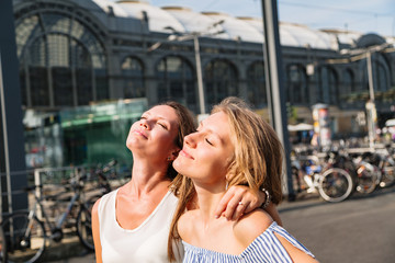 Close up portrait of two young women in city