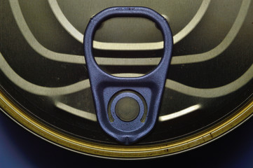 close-up photographed lid of a tin can with a key. view from above.