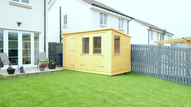 Modern Garden Designed and landscaped with newly Constructed Materials Including Newly Constructed Summer House and painted Fencing..
